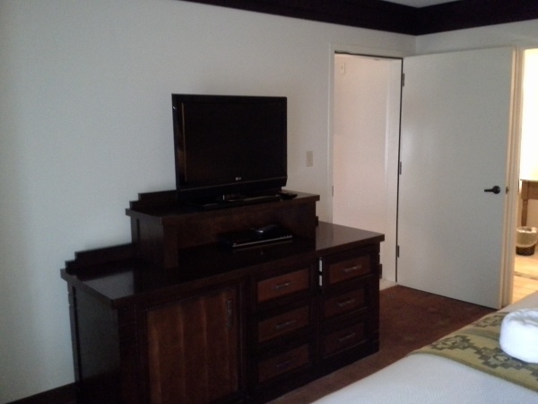 Entertainment center and fridge in the master bedroom