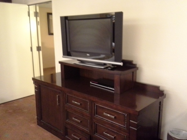 Entertainment center and fridge in double queen bedroom