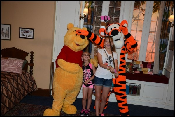 My daughter's taking a selfie with Pooh and Tigger.