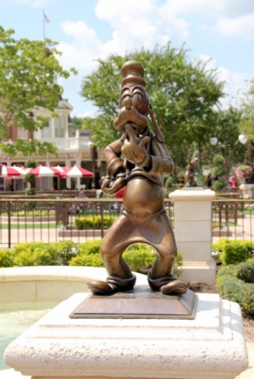 Goofy and other Disney Character statues can be found around the Magic Kingdom Central Plaza area between Main Street U.S.A. and Cinderella Castle.