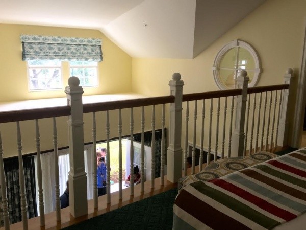 Railing in bedroom over looking living space. Take note of the dramatic vaulted ceiling! 