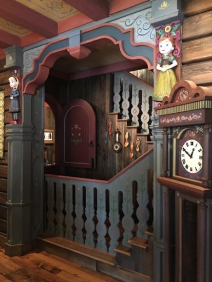 Inside Royal Sommerhus in Epcot. Discover detailed carvings of the two sisters (Anna & Elsa) and beautiful Norwegian rose painting.