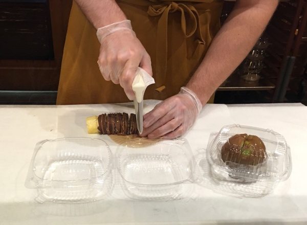 Chocolate Covered Pineapple and Carmel Apple getting sliced at Karamell Kuche - Epcot Germany Pavilion