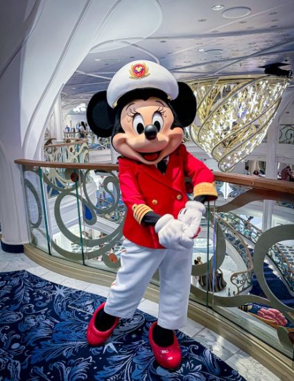 Captain Minnie Mouse meets guests on the Disney Wish