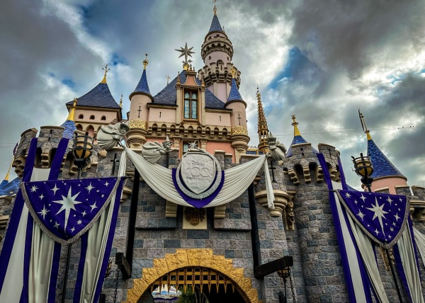 sleeping beauty castle with disney 100 celebration decorations at disneyland resort